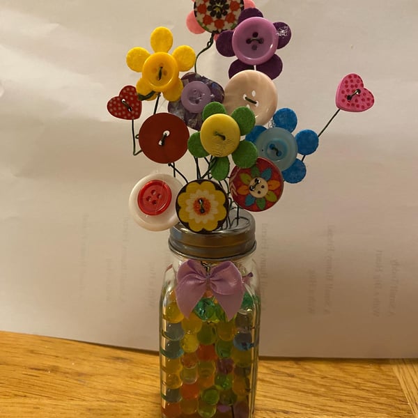 Button flower in a salt shaker vase