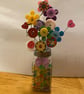 Button flower in a salt shaker vase