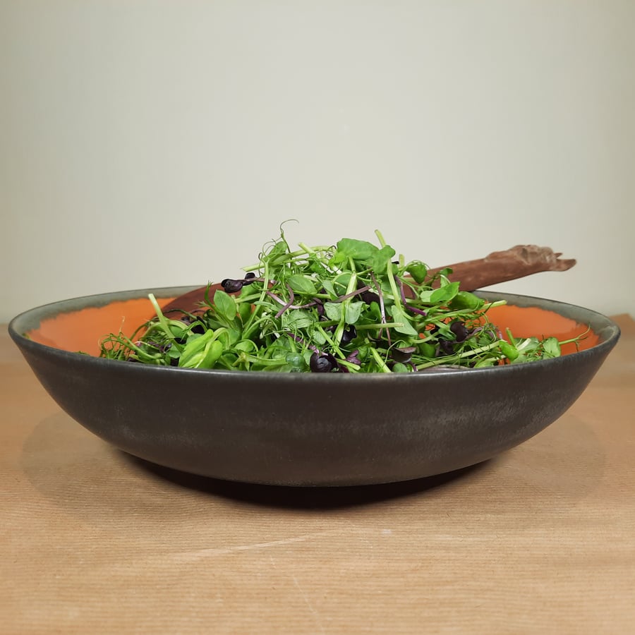 LARGE LOW BURNT ORANGE CERAMIC BOWL - with a charcoal glaze on the outside