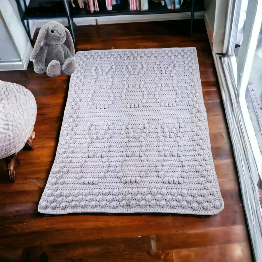 Crochet baby blanket in light grey with puff bobbly bunny pattern