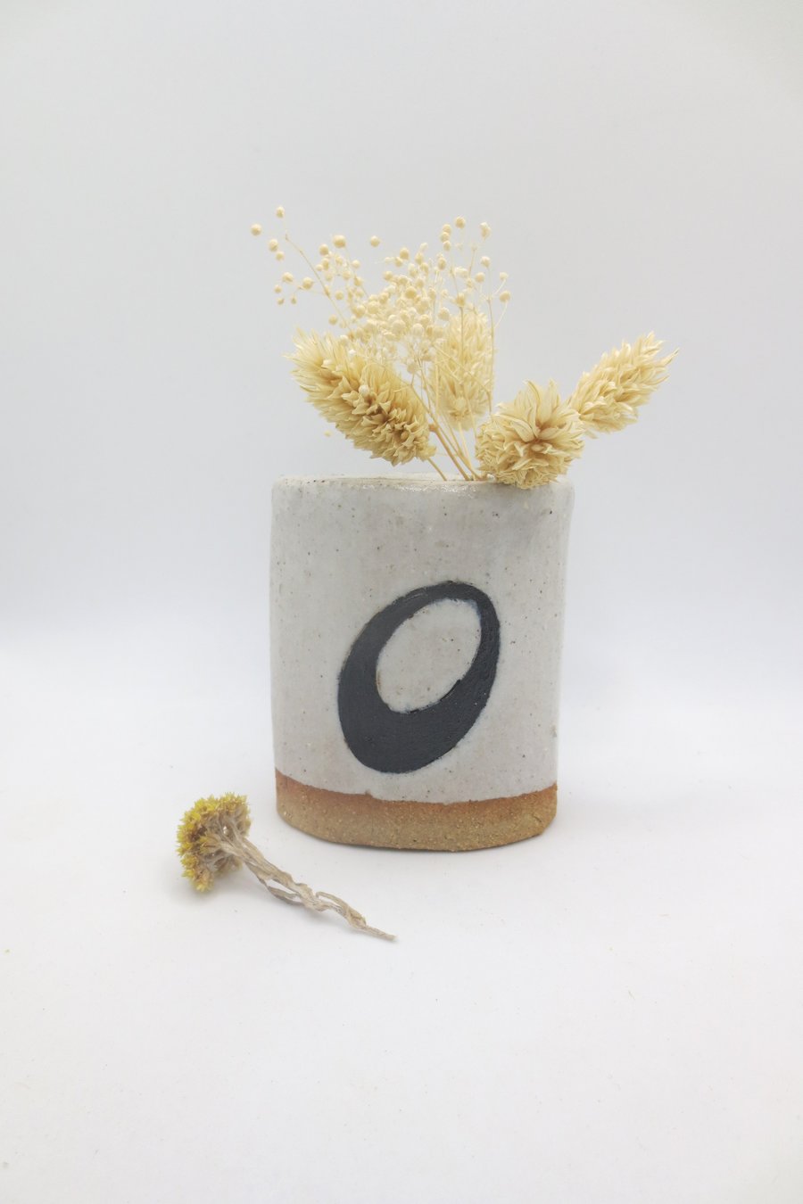 Hand-built small stoneware pottery oval vase in white and black