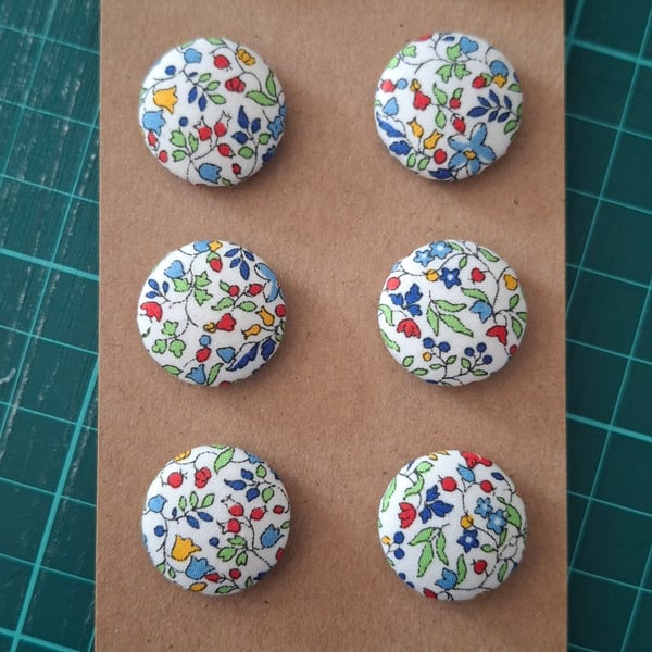Set of eight scrap bag buttons - floral design on off white background