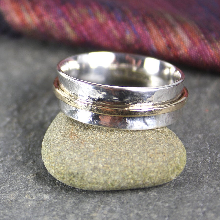 Silver and gold spinner ring.