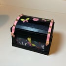 Black Wooden Trunk with Pink Decorative Detailing 