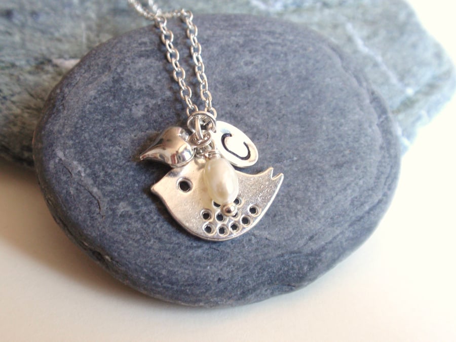 Personalised necklace with silver bird and a freshwater pearl, initial necklace