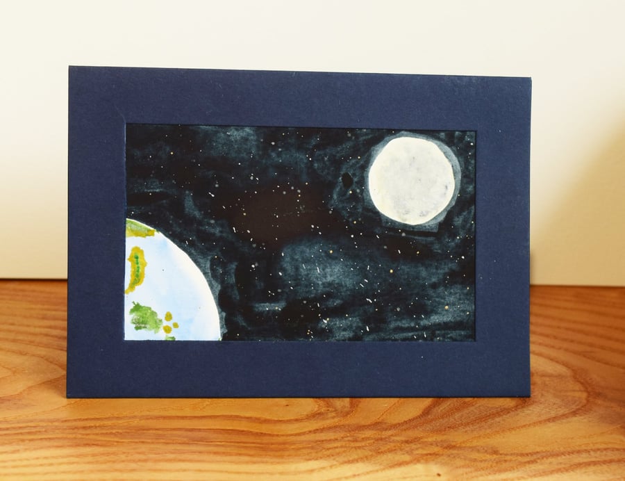 An almost familiar blue-green planet, hanging in space near a bright moon