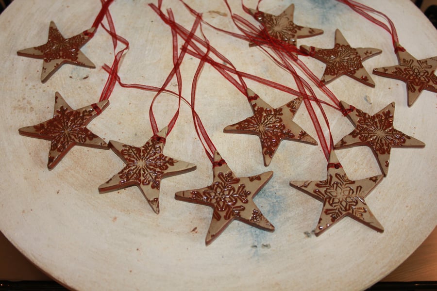 Handmade ceramic Red star hanging decoration impressed with snow flake design