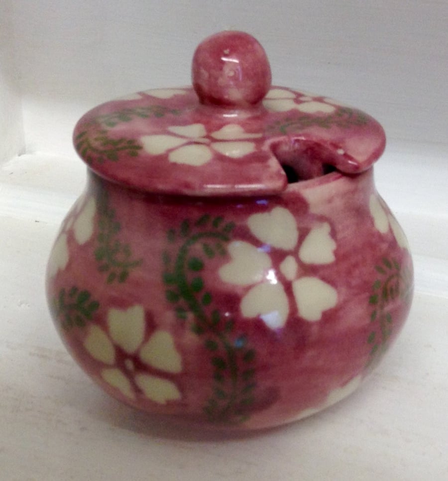 Sugar bowl or jam pot with lid in pale pink with white flowers. 