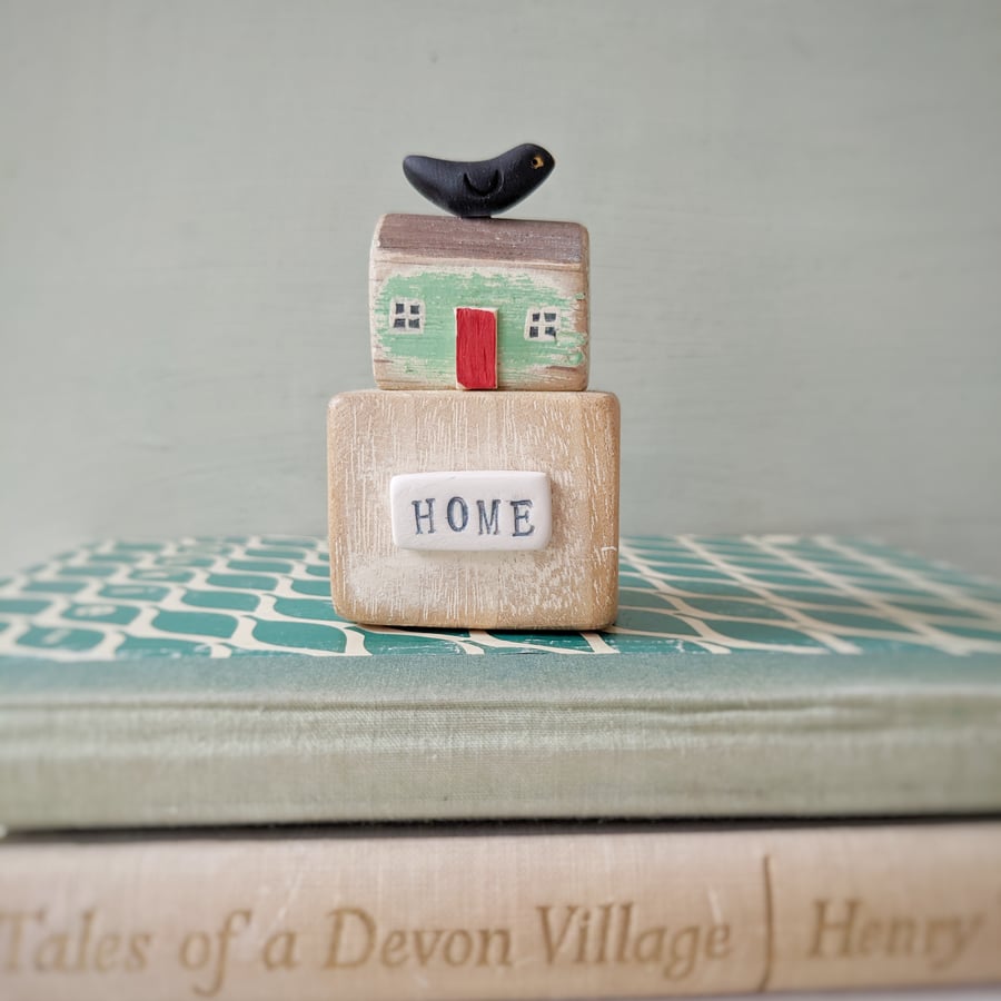 Little wooden house with clay bird 'home'