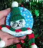 Christmas tree decoration of a Seal, airdry clay with a fabric hat and scarf.   - Image 2