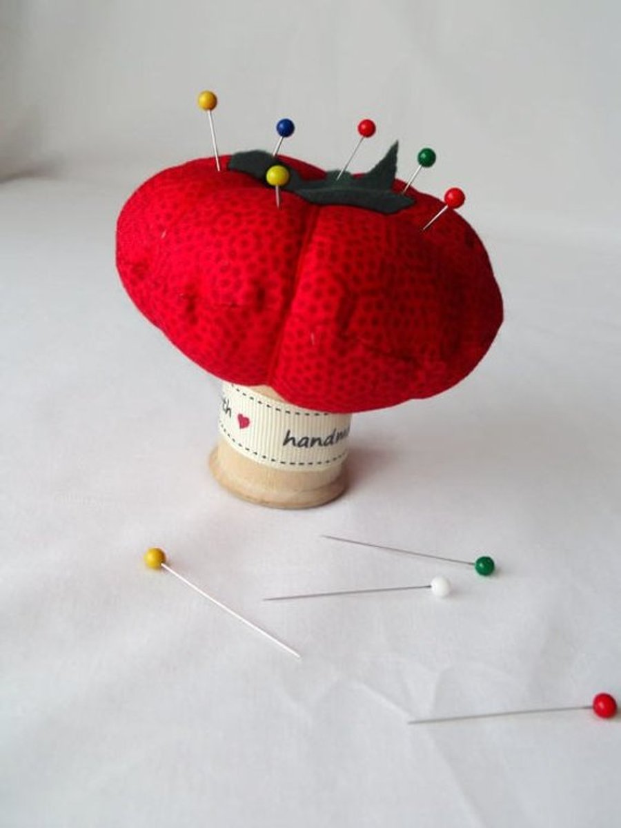 novelty tomato pin cushion on a vintage wooden bobbin