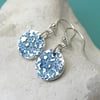 Fine silver disc earrings with blue floral surface