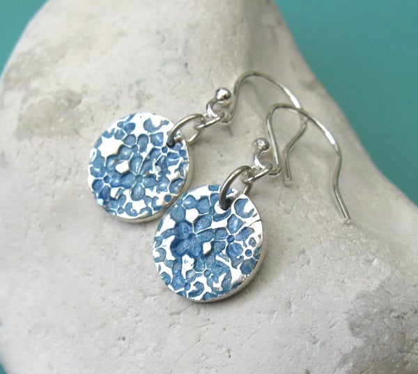 Fine silver disc earrings with blue floral surface