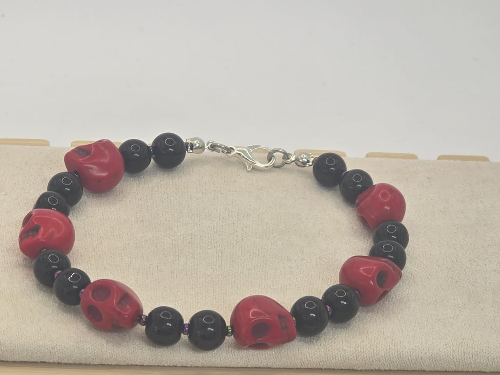 Large red skulls and black beaded bracelet 