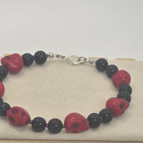 Large red skulls and black beaded bracelet 