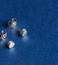 Silver cylindrical ear studs with a brush matte texture - Image 1