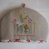 Hand embroidered floral tea cosy with cream floral lining