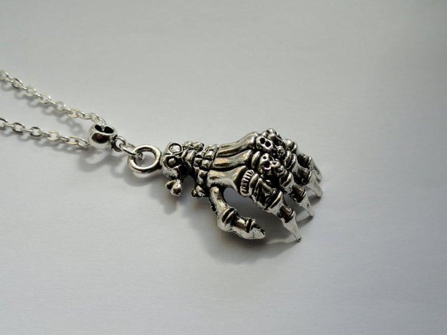 Long skeleton hand necklace