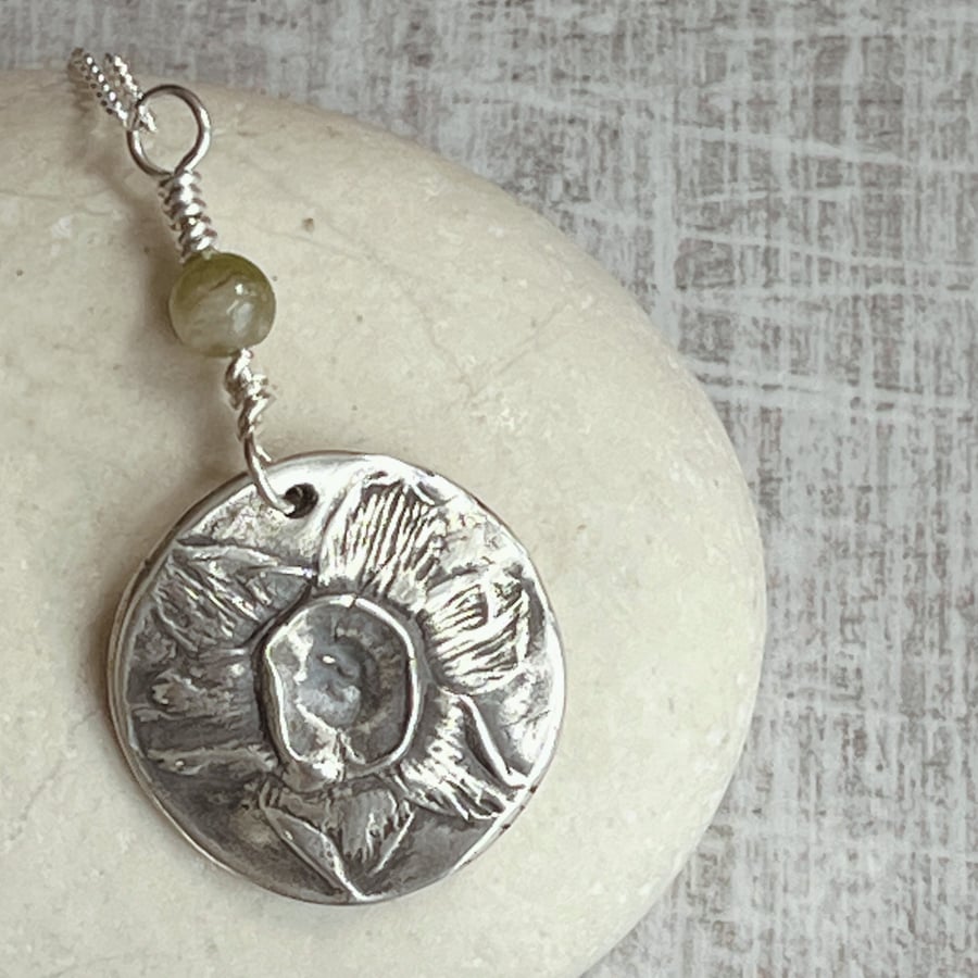 Botanical silver pendant with daffodil and tourmaline.