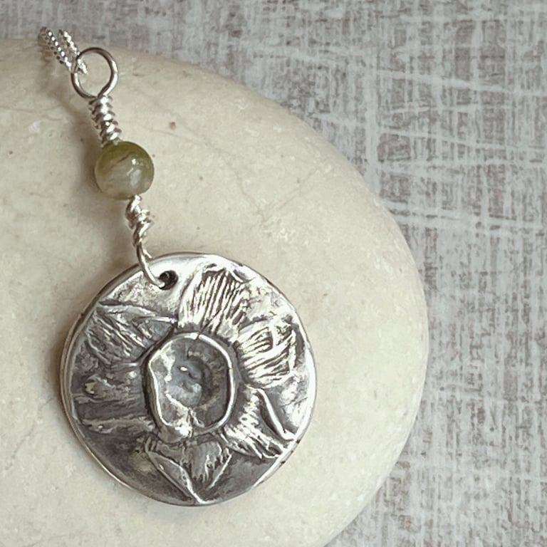 Botanical silver pendant with daffodil and tourmaline.