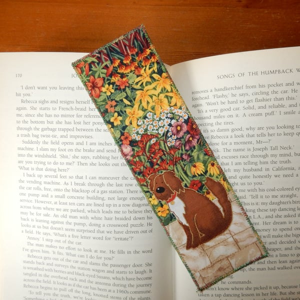Bookmark shaggy brown dog in the garden