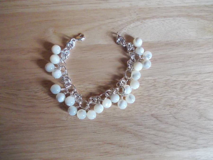 Cream shell and chainmaille charm bracelet