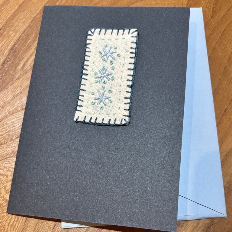 Handmade card embroidered with an abstract pattern in blues and greens