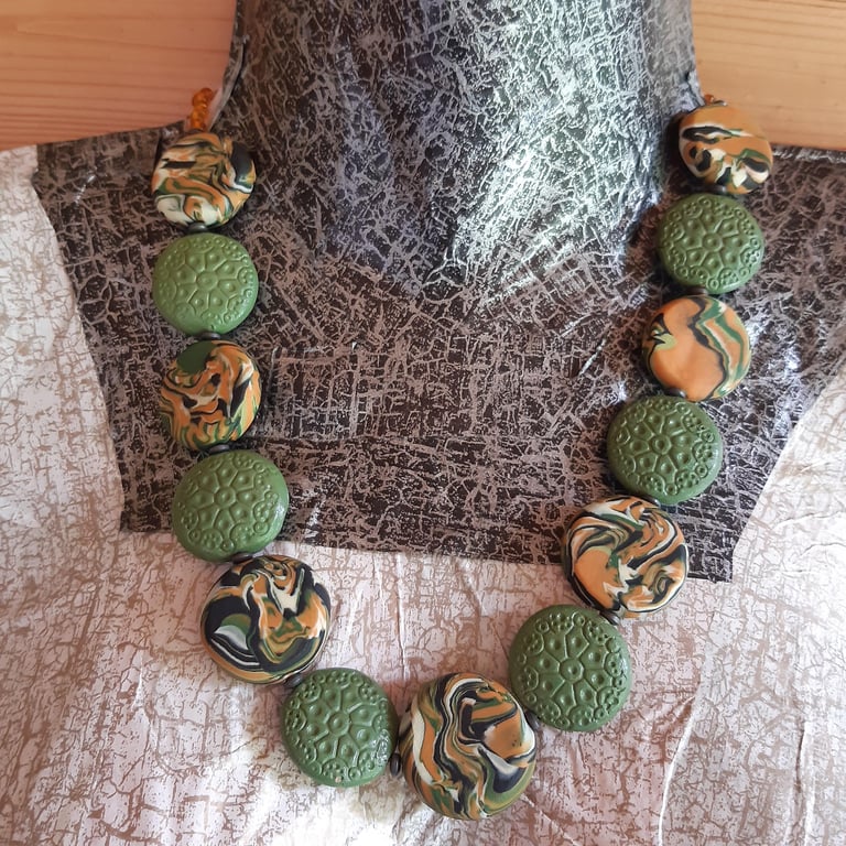 Disc shaped necklace in sage, burnt orange and black polymer clay
