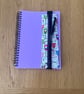 Pen or pencil holders for A5 notebooks or journals.