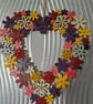 Flower wreath decorated with warm colours and embellished with sequins. - Image 3