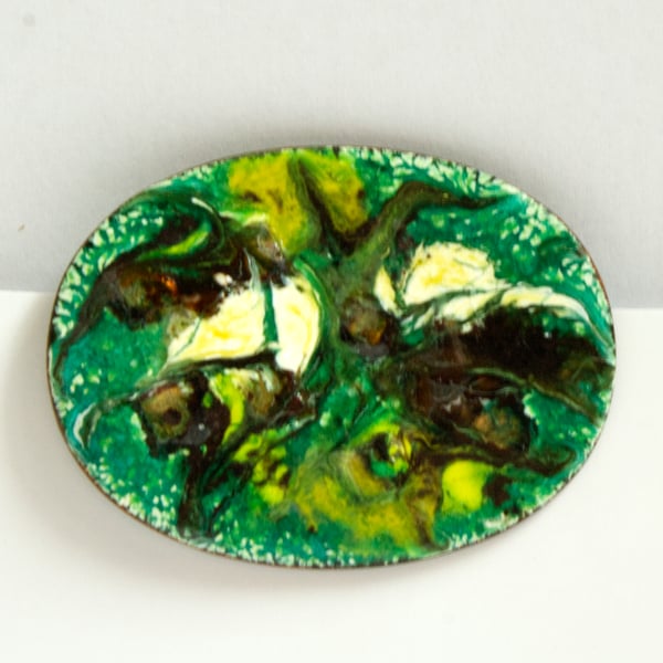 brown, white and gold scrolled  over green on white - brooch