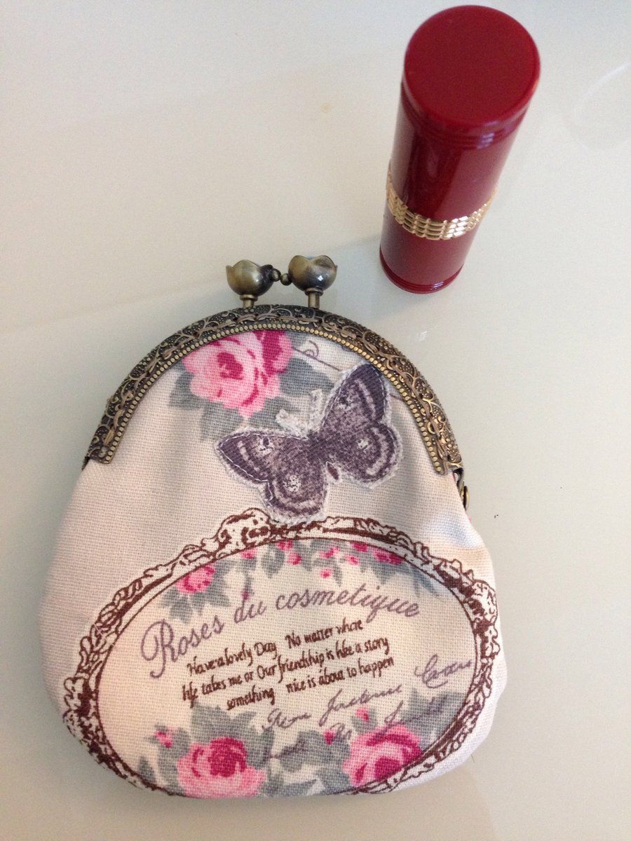 Vintage inspired purse featuring roses and an appliqued butterfly & brass frame