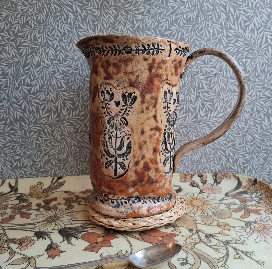folk floral jug in burnt tomato and pumpkin, see photos for crack above handle