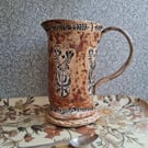 folk floral jug in burnt tomato and pumpkin, see photos for crack above handle