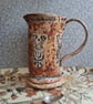 folk floral jug in burnt tomato and pumpkin, see photos for crack above handle