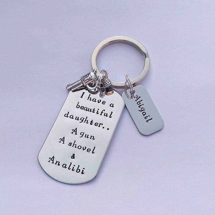 Hand stamped keyring 'I have a beautiful daughter..a gun, a shovel and an alibi'