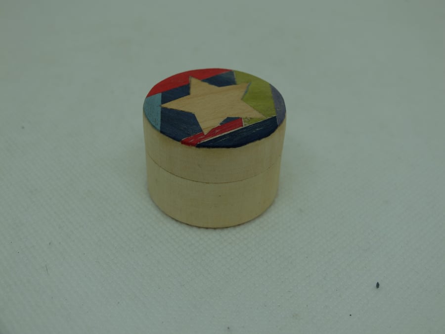 Tiny round wooden pot with colourful lid with inset star, hand-veneered