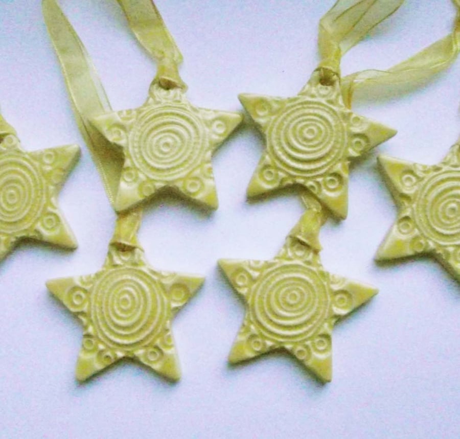 Set of six little yellow handmade ceramic star decorations