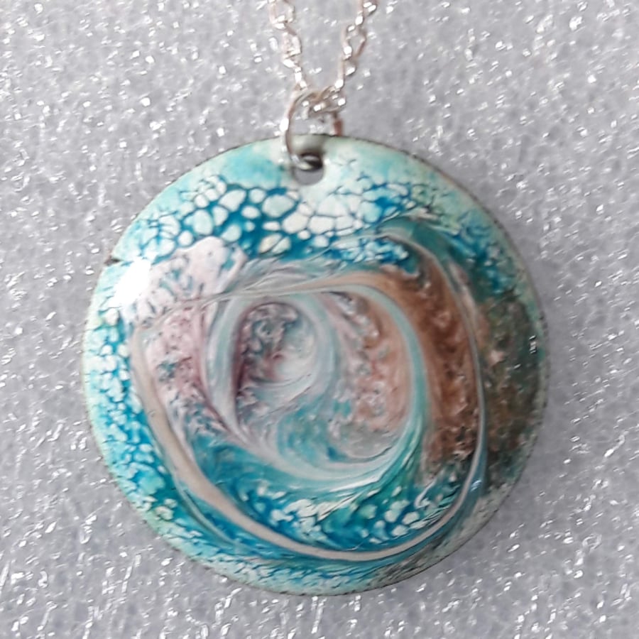 round pendant - scrolled brown and pale purple  on blue-green on white enamel