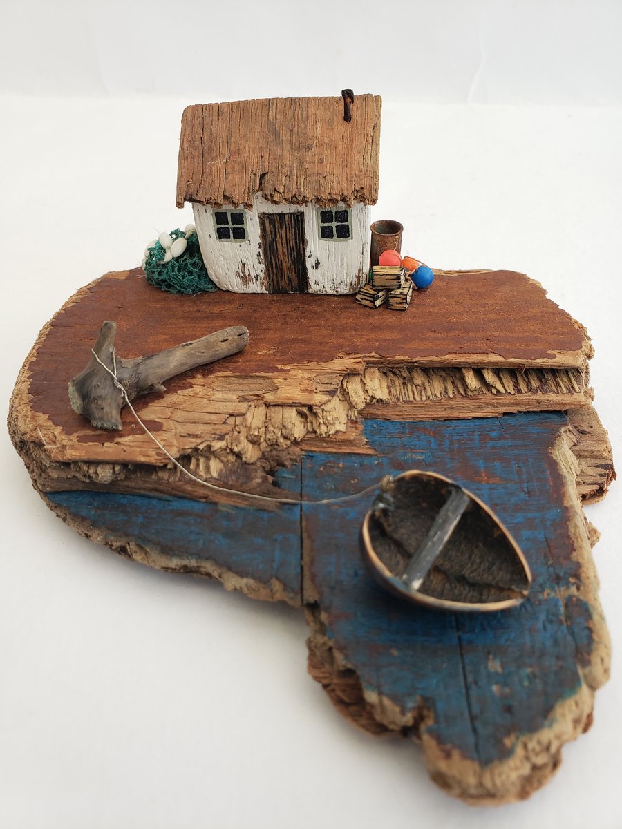 'The Coracle'  driftwood house and boat scene