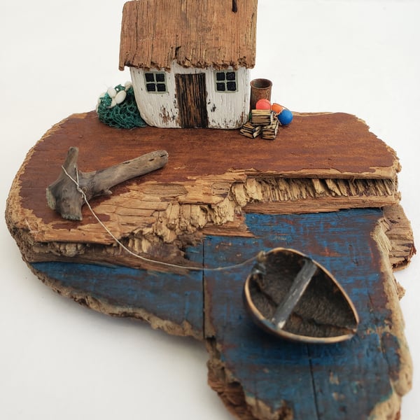 'The Coracle'  driftwood house and boat scene