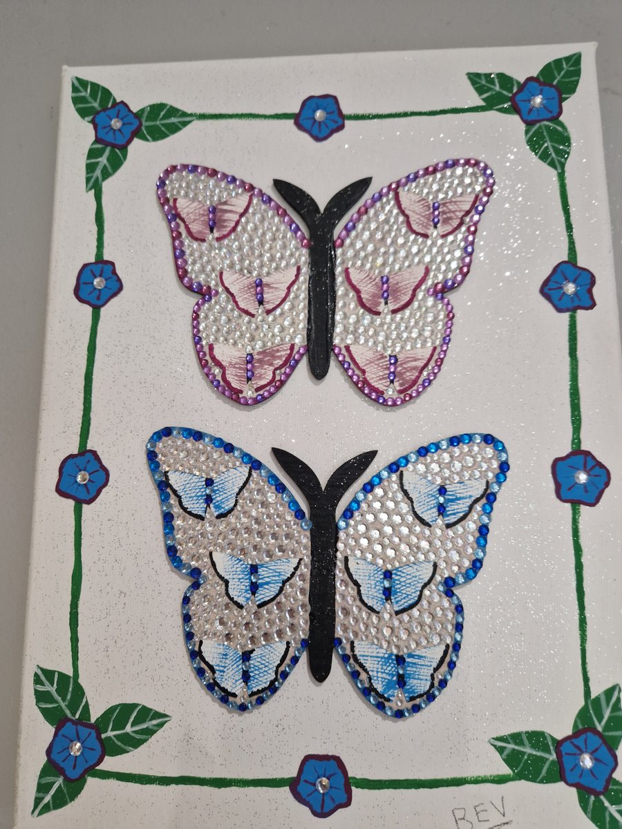 Wooden butterflies on canvas. 