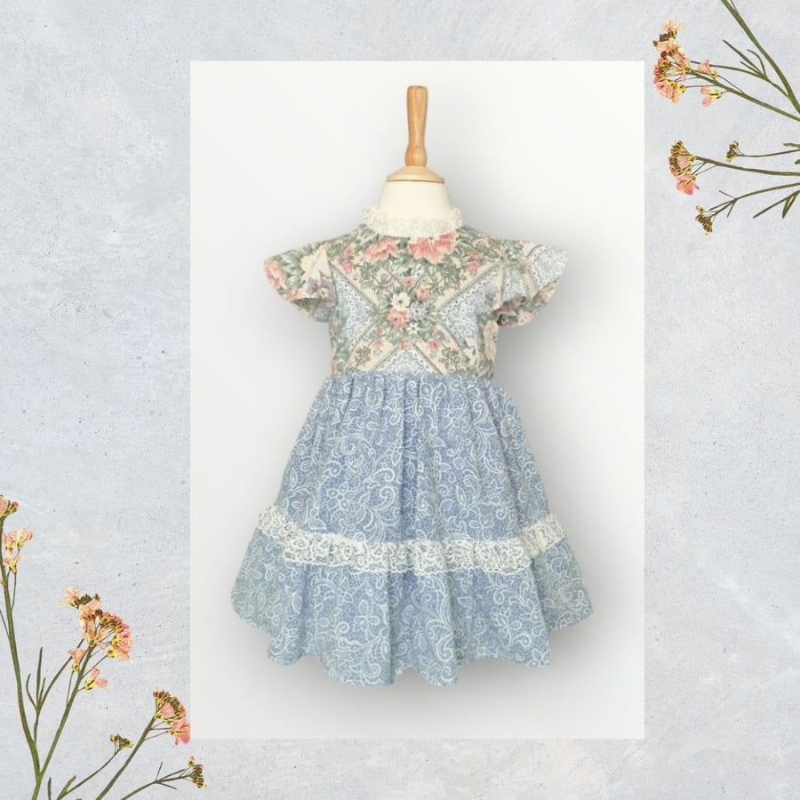 Blue Paisley and Rose Print Dress With Lace Trim And Frills. Age 2-3yrs