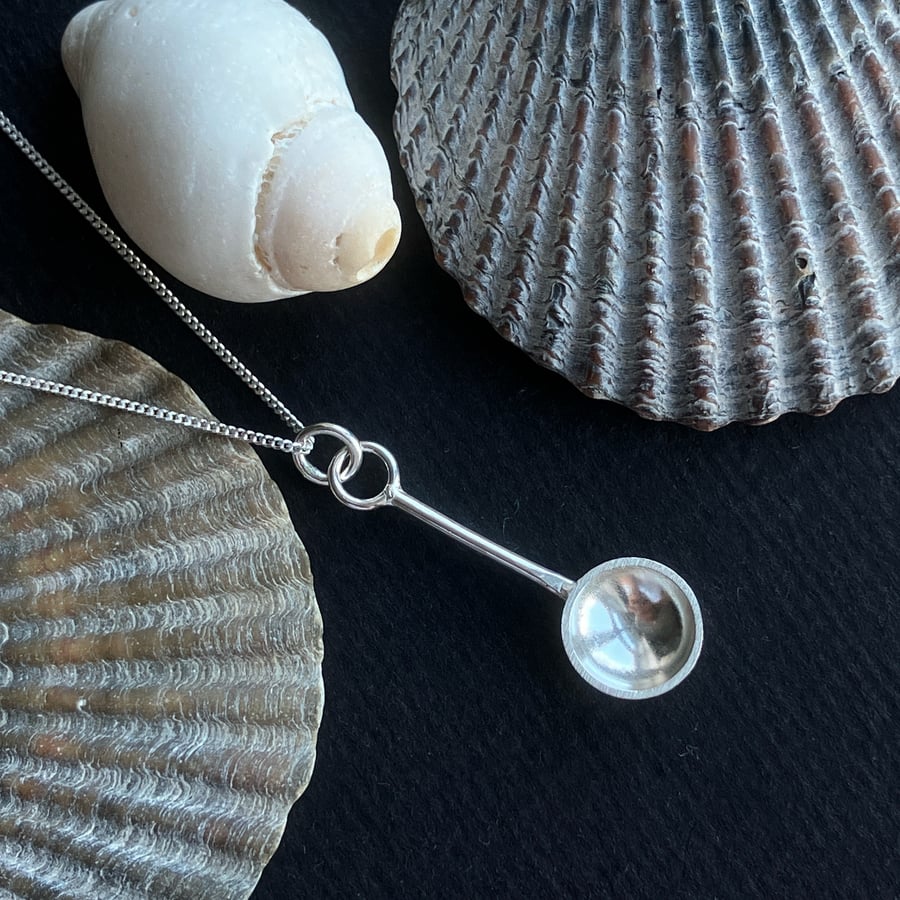 Sterling silver spoon pendant with hammered detail.