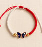 Red and White Macramé Bracelet with Blue Butterfly – Adjustable