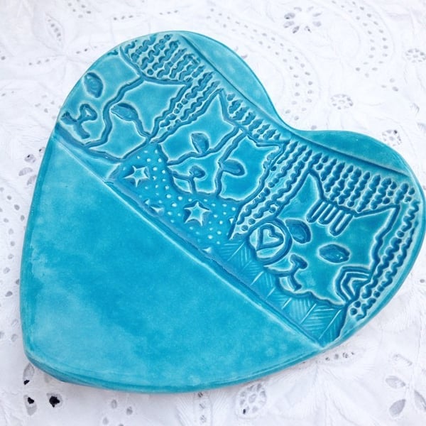 Turquoise heart ceramic dish imprinted with a cat face design