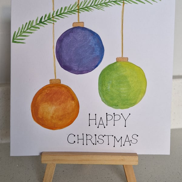 Three hanging colourful Christmas baubles Christmas card handpainted watercolour