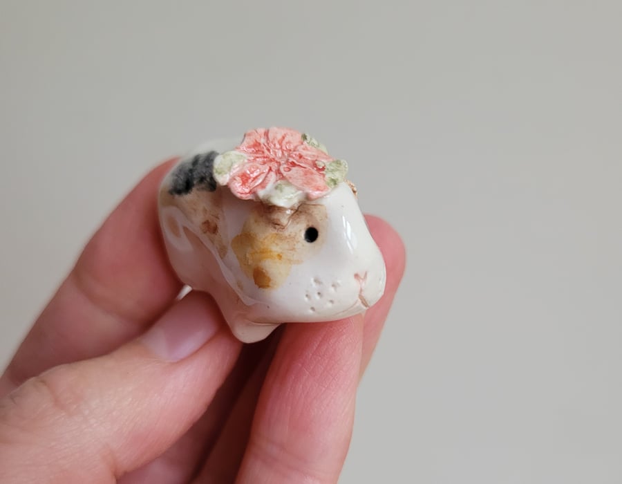 Ceramic guinea pig figure with Christmas poinsettia flower piggie figurine
