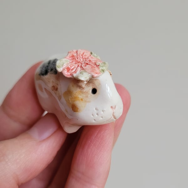 Ceramic guinea pig figure with Christmas poinsettia flower piggie figurine