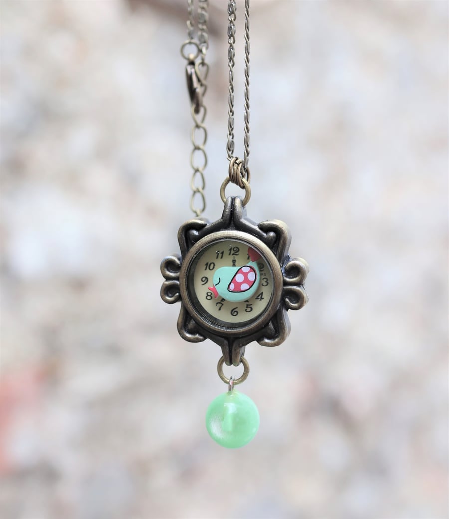 Upcycled ladies watch case decorated with a bird charm handmade necklace 